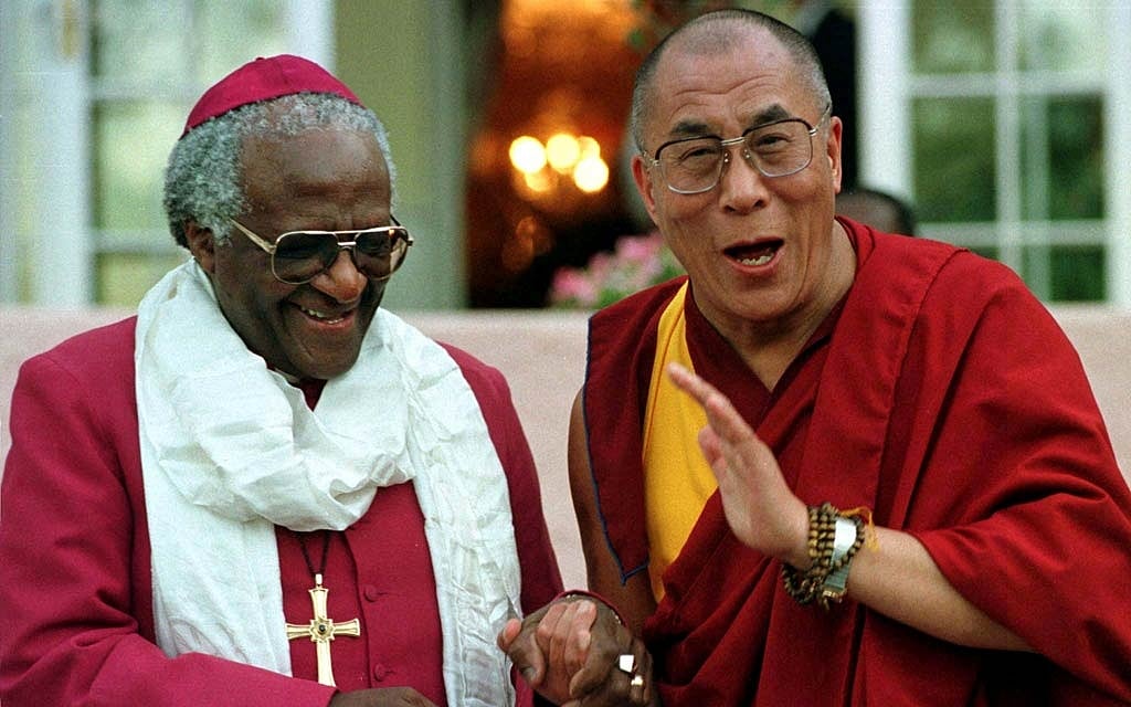 FILE PHOTO: Archbishop Desmond Tutu shares a joke with the Dalai Lama after their meeting, August 21. The Dalai Lama is in the country on a short visit, the first by the Bhuddist leader. -REUTERS/Mike Hutchings/File Photo 