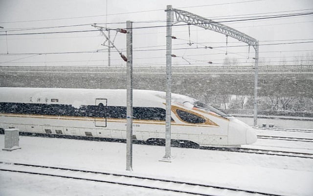A view of one high-speed train from the window of another in Beijing, Feb 13, 2022. James Hill/The New York Times 